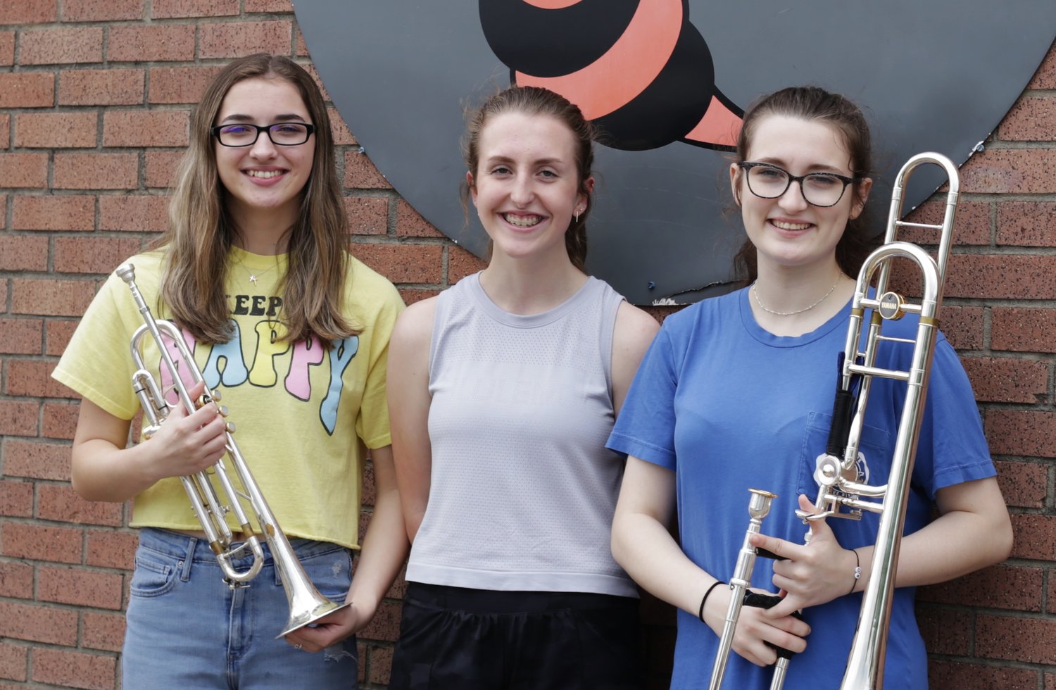 Taking a break from an early June music session were (from left) Brass Captain Ali Jordan, Drum Major Maddie Tucker and Brass Captain Gabby Wolf.